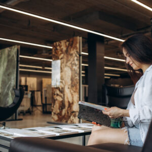 a woman looks at a catalog of goods in a hardware store