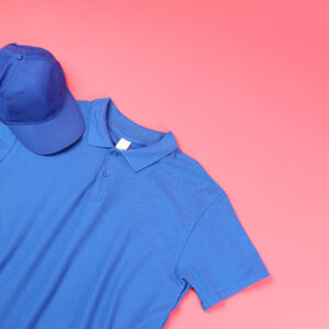 Blank t-shirt and cap on pink background