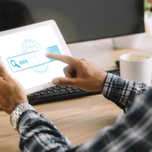 cropped shot of seo manager using tablet with website on screen