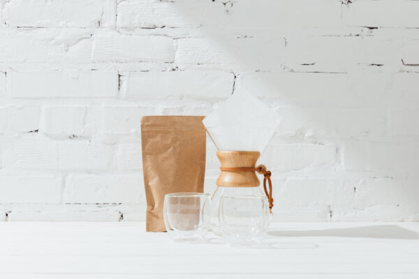 Glass mugs, chemex and paper package with coffee